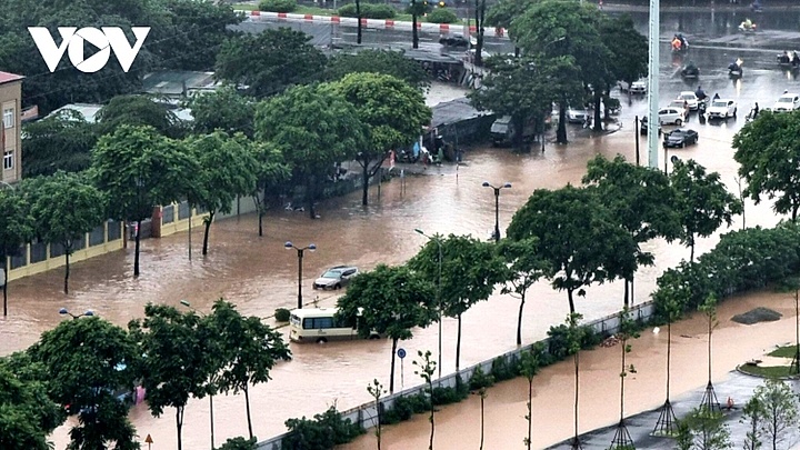 Hanoi streets turn into rivers after heavy downpours